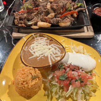 El Patron Grill and Cantina - Fajita for two which included steak, chicken, shrimp and pork with 2 sides of beans and rice. - Mexican Near Me - Riverview, Florida El Patron Grill and Cantina - Fajita for two which included steak, chicken, shrimp and pork with 2 sides of beans and rice. - Mexican Near Me - Riverview, Florida