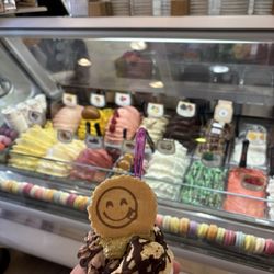 Medium cup of gelato with pistachio, hazelnut, Dubai chocolate covering, and chocolate drizzle