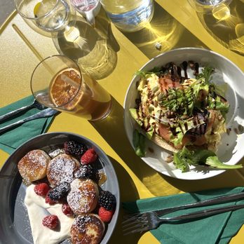 Need To Eat - Pictured from left to right:   Syrniki with Caramel and Berries, Coffee Drip mixed with Orange Juice, and Avocado Toast with Salmon - Caterers Near Me - Poway, California
