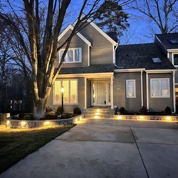 JZL Landscaping Services - the front of a house at night - Landscaping Near Me