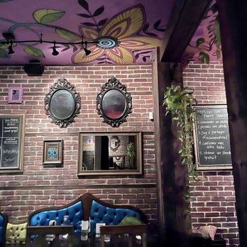 Rasoï - a brick wall with a mural of butterflies on it - Indian Near Me - Montreal, Quebec