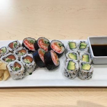 Ubi Sushi - a plate of sushi and a bowl of dipping sauce - Sushi Bars Near Me - Montreal, Quebec