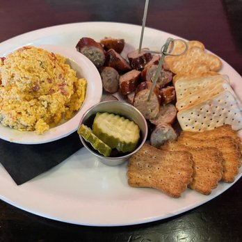 Mike’s Tavern - Smoked sausage with Gouda, assorted crackers, in-house made pimento cheese, and pickles. - New American Near Me - Chattanooga, Tennessee Mike’s Tavern - Smoked sausage with Gouda, assorted crackers, in-house made pimento cheese, and pickles. - New American Near Me - Chattanooga, Tennessee