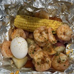 Grub Shack - The LCB Feast with garlic butter shrimp, sausage, potatoes, and 1 boiled egg.