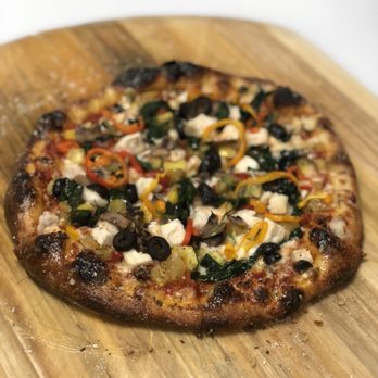 The Pizza Pitt - a pizza on a wooden board - Pizza Near Me - Atlanta, Georgia The Pizza Pitt - a pizza on a wooden board - Pizza Near Me - Atlanta, Georgia