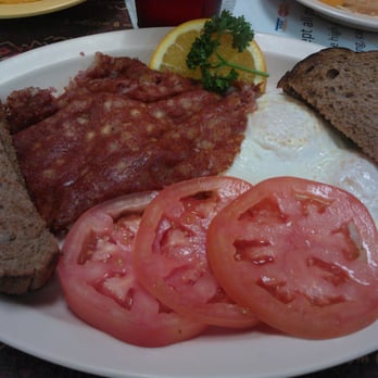 Sunnyside Cafe - Two eggs over easy, corned beef hash, sliced tomatoes & wheat toast....heaven!! - Cafes Near Me - Melbourne Beach, Florida