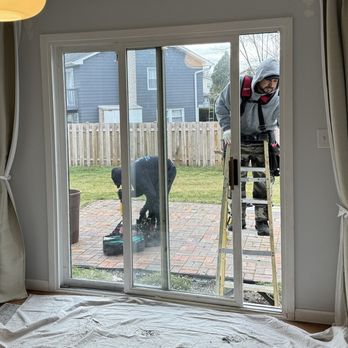 Jacobs 1 Construction - David and Jacob preparing to remove the old patio door. - Siding Near Me