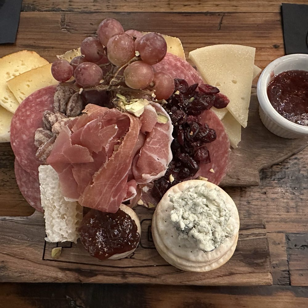 Charcuterie board on anvil shaped wood block Charcuterie board on anvil shaped wood block