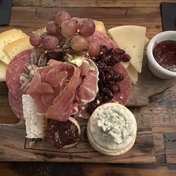 Charcuterie board on anvil shaped wood block Charcuterie board on anvil shaped wood block