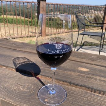 Sarver - a glass of red wine on a wooden table - Wineries Near Me - Eugene, Oregon Sarver - a glass of red wine on a wooden table - Wineries Near Me - Eugene, Oregon