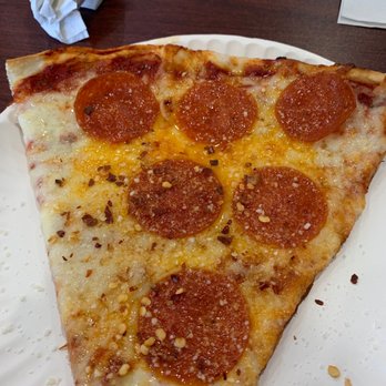 Brooklyn Pizzeria - Slice of pepperoni, I added cheese & red pepper to the pizza before I took this picture. - Pizza Near Me - Atascocita, Texas