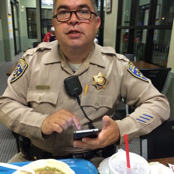 Primo's Ticket - a man in a police uniform sitting at a table with a plate of food - Ticket Sales Near Me - El Monte, California