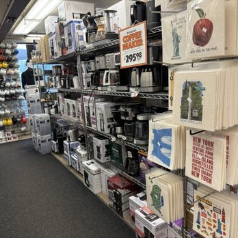 Zabar's - The aisle features coffee makers on metal shelves, with New York City-themed tote bags and mugs hanging nearby. - Bakeries Near Me - New York, New York