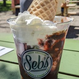 a cup of ice cream with a cone sticking out of it