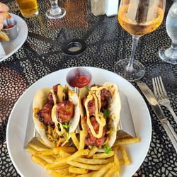 General Tso's chicken with French fries dusted with Rosemary. Glass of Rose.