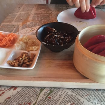Nanam Eatery - red pockets are similar to pork buns but red with beetroot juice. tasty pulled pork in a rich sauce, and assorted crunchy sides - Filipino Near Me - Auckland, AUK