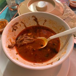a bowl of soup with a spoon in it a bowl of soup with a spoon in it