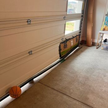 Cesar Garage Door Services - Before picture of broken bottom retainer and window - Garage Door Services Near Me - Cedar Park, Texas