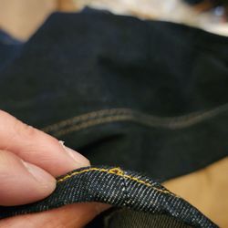 Visible inconsistencies in the stitching and reattachment seam.