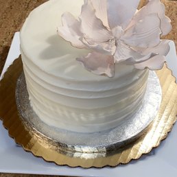 a white cake with a flower on top