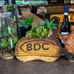 Broward Design Center - Our BDC cutting board along with our double turtle wine holder!