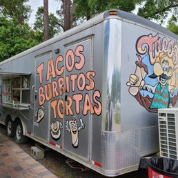 a taco truck parked on the side of the road a taco truck parked on the side of the road