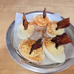 Deviled eggs appetizer with a crispy bacon wedge Deviled eggs appetizer with a crispy bacon wedge