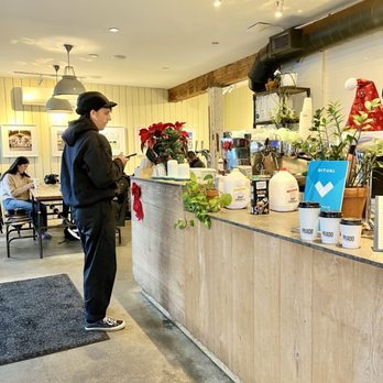 Prado Cafe - a man standing at the counter - Coffee & Tea Near Me - Vancouver, British Columbia Prado Cafe - a man standing at the counter - Coffee & Tea Near Me - Vancouver, British Columbia