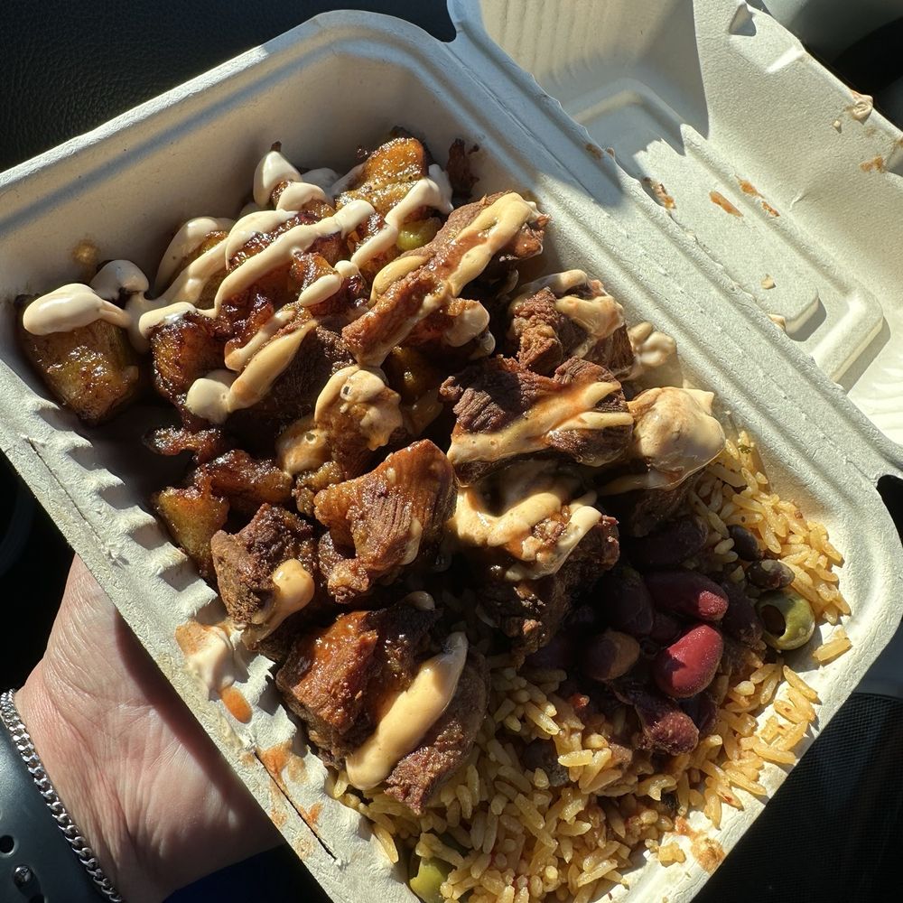 Boriqua Kitchen - (Chefs special) Deep fried pork shoulder with arroz con gandules, and habichuelas. Topped with BK sauce. - Food Trucks Near Me