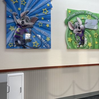 Chuck E. Cheese - a wall with three paintings on it - Pizza Near Me - Phoenix, Arizona