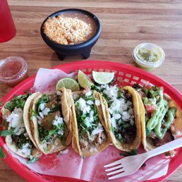 5 tacos + beans and rice. 2 spicy pork, pork belly, lamb, steak. Awesome! Lamb is my new favorite!
