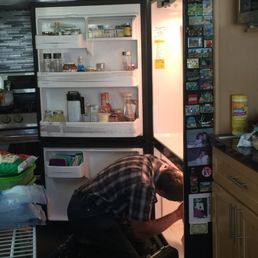 Mikhail working on our refrigerator...and he fixed it!