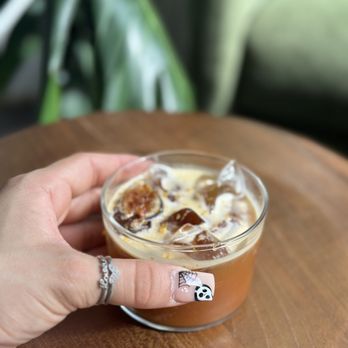 Composition Coffee - a hand holding a cup of coffee - Coffee & Tea Near Me - West Palm Beach, Florida Composition Coffee - a hand holding a cup of coffee - Coffee & Tea Near Me - West Palm Beach, Florida