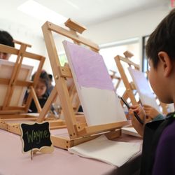 Acme Art Studio - A party attendee following along to our painting teacher's instructions
