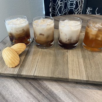 The Rusty Grind - four different drinks on a wooden tray - Coffee & Tea Near Me - Hallettsville, Texas The Rusty Grind - four different drinks on a wooden tray - Coffee & Tea Near Me - Hallettsville, Texas