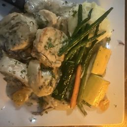 Stuffed Chicken breast with grilled onions and mushrooms and stuffed with spinach and covered with Alfredo sauce.