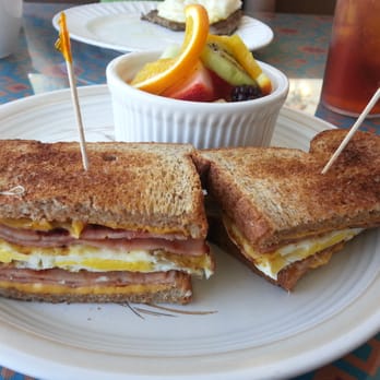 Kimmie's Coffee Cup - Fried egg, ham, and cheese sandwich on wheat with fresh fruit. - Breakfast & Brunch Near Me - Cypress, California Kimmie's Coffee Cup - Fried egg, ham, and cheese sandwich on wheat with fresh fruit. - Breakfast & Brunch Near Me - Cypress, California