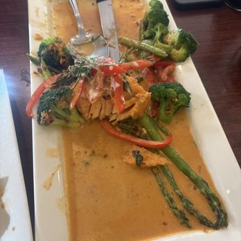 Thai Delicious Restaurant - Salmon in curry sauce with broccoli and asparagus. - Thai Near Me - Tigard, Oregon Thai Delicious Restaurant - Salmon in curry sauce with broccoli and asparagus. - Thai Near Me - Tigard, Oregon