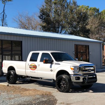 Seaside Flooring - a white truck parked in front of a building - Flooring Near Me - Wilmington, North Carolina