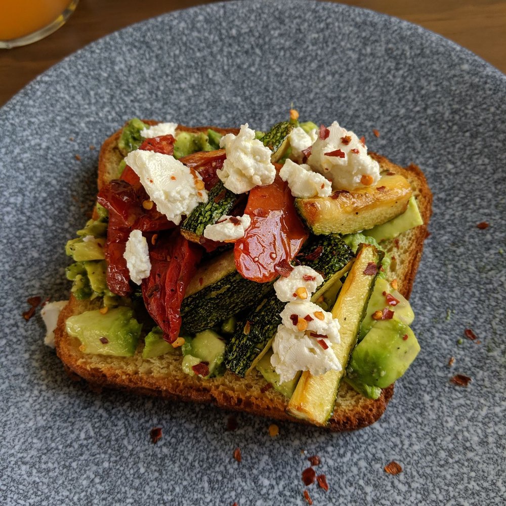 Lara & Luca - Avocado toast with goat cheese and sun-dried tomatoes with zucchini. - Breakfast & Brunch Near Me - Tulum, ROO Lara & Luca - Avocado toast with goat cheese and sun-dried tomatoes with zucchini. - Breakfast & Brunch Near Me - Tulum, ROO