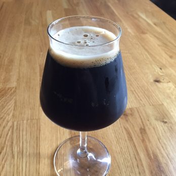 Fuzzy Bubbler - a glass of beer on a wooden table - Bars Near Me - Quincy, Illinois