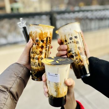 Tiger Sugar - two people holding cups of iced coffee - Bubble Tea Near Me - Minneapolis, Minnesota Tiger Sugar - two people holding cups of iced coffee - Bubble Tea Near Me - Minneapolis, Minnesota