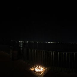Sit by the fire overlooking the Calcasieu River and old I-10 bridge.