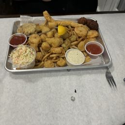 Fried crab legs, scallops, shrimp, fish and hush puppies