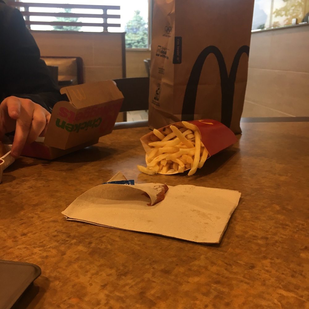 a person eating a meal at a table a person eating a meal at a table