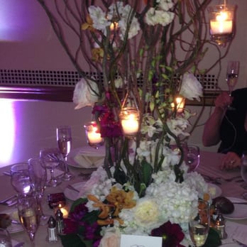 Laura Clare Floral Design - October Wedding Center Piece 2 - Small trees with flowers tufted in the branches with hanging tea lights. - Florists Near Me - Hoboken, New Jersey Laura Clare Floral Design - October Wedding Center Piece 2 - Small trees with flowers tufted in the branches with hanging tea lights. - Florists Near Me - Hoboken, New Jersey