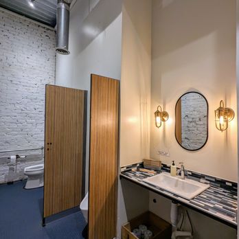 Banshee - Inside the men's restroom. Toilet, urinal, sink. Clean. High ceilings. - New American Near Me - Atlanta, Georgia