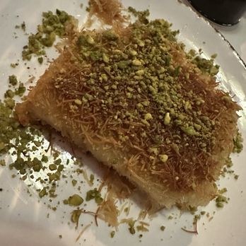 Aleppo's Kitchen - KNAFEH $9 Delicate shreds of filo pastry dough soaked in rosewater syrup with a sweet cheese filling and topped with crushed pistachios. - Mediterranean Near Me - Anaheim, California