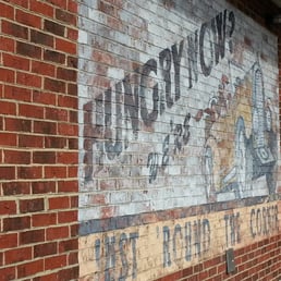 ws a faded sign on the side of a building ws a faded sign on the side of a building