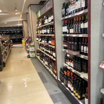 SAQ - a wide aisle of wine in a store - Beer, Wine & Spirits Near Me - Montreal, Quebec